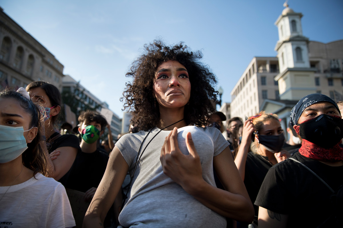 "I think it's important for me to do this now so my daughter doesn't have to do this in 15 years," said Twana Buck who brought her one-year-old daughter Bonita Buck-Parker to the George Floyd protests near the White House in Washington, D.C., on Tuesday, June 2, 2020. Buck was hoping that her daughter's presence would calm the protesters and law enforcement, but within minutes after arriving to the front line, she found herself and her daughter sprayed with chemical gas so, trembling, she backed away with her daughter protectively tucked under her shirt. Floyd, a black man, died last week when a white police officer held his knee on the man's neck during an arrest in Minneapolis. After the previous day's aggressive tactics by law enforcement to clear Lafayette Park so Trump could have a photo op, the day passed relatively peacefully with several thousand demonstrators chanting and taunting the officers.