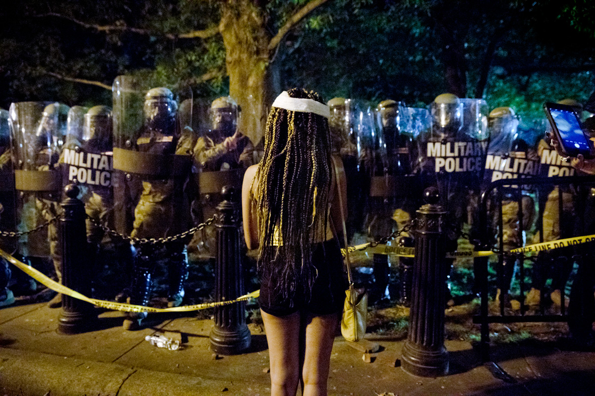 After a bloody injury from being hit in the head with a pepper pellet at close range, Taylor Lukas, 20, of Bladensburg, Md., returns to the police line to protest. The death of George Floyd in Minneapolis ignited protests around the country including near the White House for a second night, in Washington, D.C., on Saturday, May 30, 2020. Floyd, a black man, died when a white police officer held his knee on the man's neck during an arrest. Protesters broke store windows, set garbage bins on fire and threw water bottles at law enforcement who shot tear gas, fireworks and used pepper spray against the crowds.