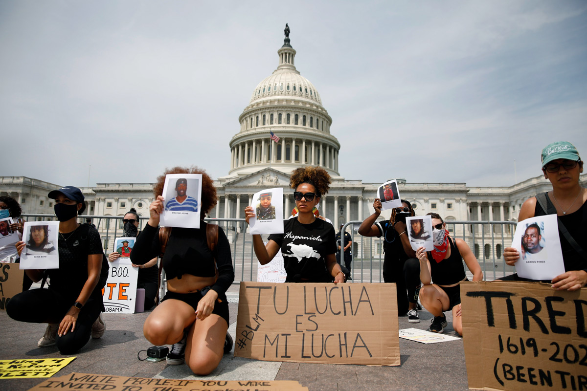 Protesters Heyssis Castillo and Katherine Bonilla, center left and right, demonstrate against the death of George Floyd and police brutality in Washington, D.C., on Saturday, June 6, 2020. Floyd, a black man, died May 25 when a white police officer held his knee on the man's neck during an arrest in Minneapolis. His death has sparked demonstrations throughout the country and the world.