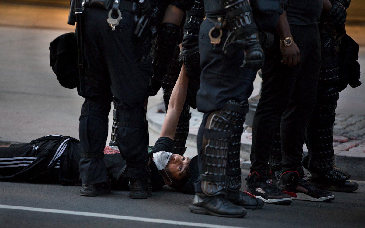 Near the White House, demonstrators peacefully protesting the death of George Floyd are encircled by the police and eventually arrested in Washington, D.C., on Monday, June 1, 2020. Floyd, a black man, died when a white police officer held his knee on the man's neck during an arrest in Minneapolis last week. The military police, National Guard and Washington police aggressively shoved demonstrators and fired stun grenades, sting balls and chemical gas to drive them away from the White House where President Trump then walked to St. John's Church for a photo op.