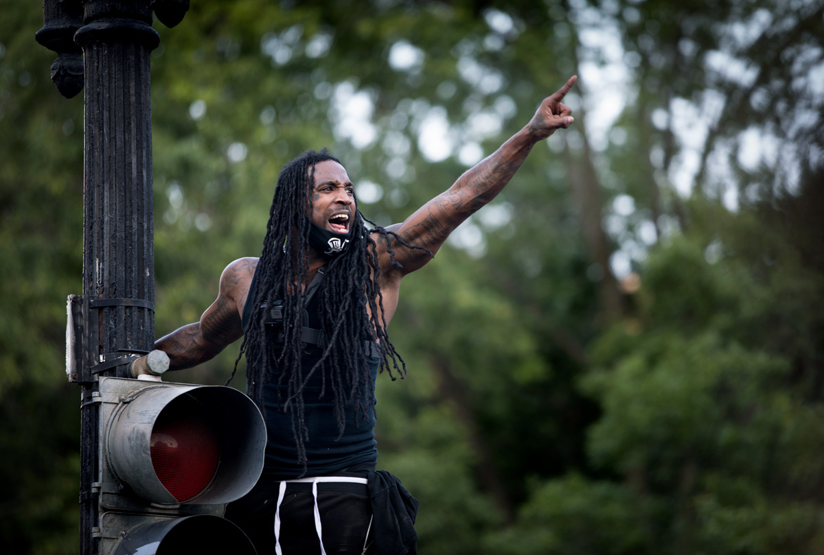 Mike Dangelo addressed the demonstrators atop a traffic light during the George Floyd protests that have gripped the nation's capital near the White House in Washington, D.C., on Tuesday, June 2, 2020. Floyd, a black man, died last week when a white police officer held his knee on the man's neck during an arrest in Minneapolis last week. After yesterday's aggressive tactics by law enforcement to clear Lafayette Park so Trump could have a photo op, the day passed relatively peacefully with several thousand demonstrators chanting and taunting the officers.