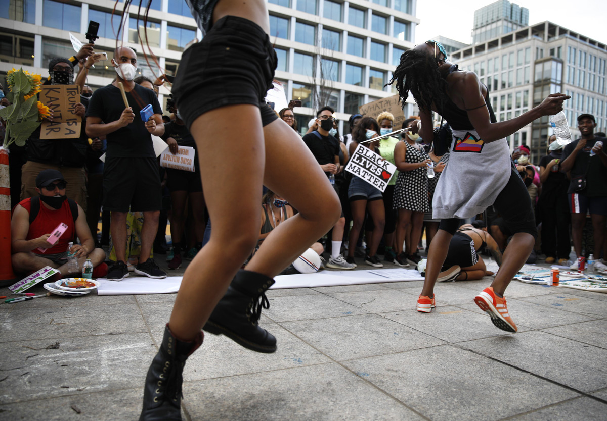Blake Avenue and Amina Smith, left and right, danced to drums during demonstrations on the newly minted Black Lives Matter Plaza in response to the death of George Floyd and police brutality in Washington, D.C., on Saturday, June 6, 2020. Floyd, a black man, died May 25 when a white police officer held his knee on the man's neck during an arrest in Minneapolis. His death has sparked demonstrations throughout the country and the world.