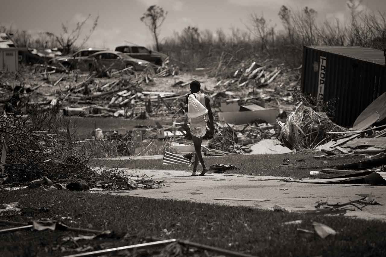 A week after the storm, a man wanders confused through the mangled structures and debris left by Hurricane Dorian in Marsh Harbour after it decimated the island of Abaco in the Bahamas a week ago on Sept. 9, 2019.