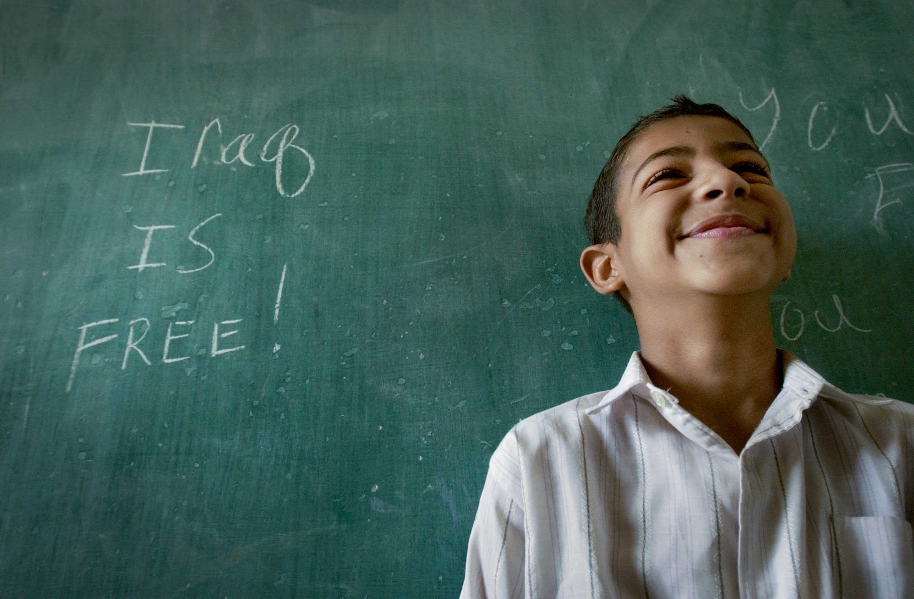 Uniss Mohammad Salman, 10, returned to Al Amtithal Elementary School to a message on the chalkboard from the U.S. military -- “Iraq is free!” Al Amtithal was the first school to reopen in Baghdad, Iraq, after the U.S.-led invasion in 2003.