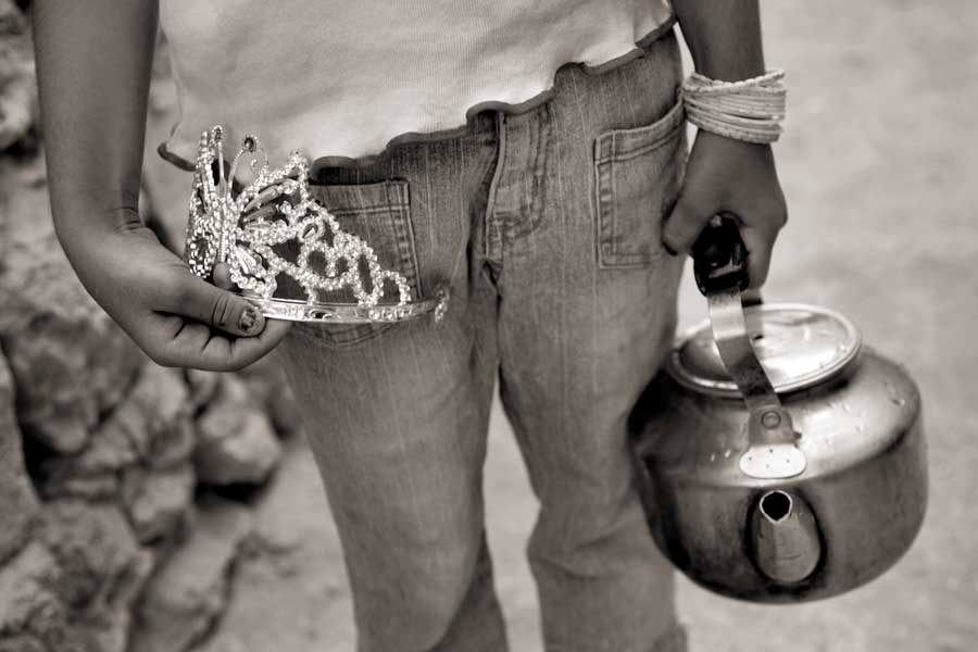 A tiara and a tea kettle represent the hopes and reality for a young Ezidi girl attending the annual Jamai Festival in Iraqi Kurdistan. The group, which is an ancient clan of Kurds, regards itself as the chosen people of Adam and the oldest faith in history. In 2014, ISIS killed Ezidis en masse and sexually enslaved thousands of women and girls, causing many to commit suicide and leading to one of the gravest humanitarian tragedies under ISIS.