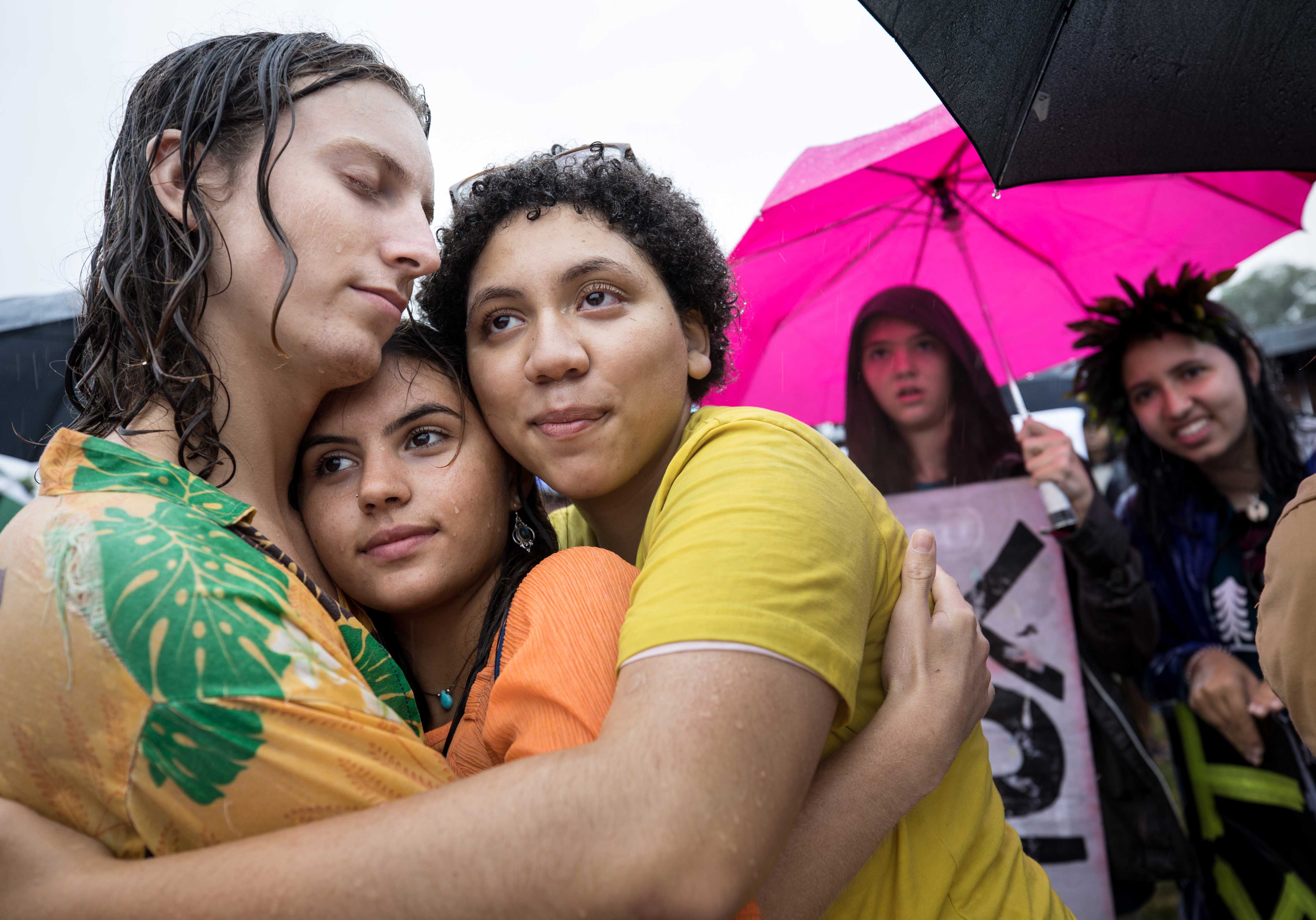 Jaiia Cerff, Mia Eastman and Imara Rose Glynph, left to right, hug in the rain as they listen to speakers at the Youth Climate March on the National Mall in Washington, D.C. The Zero Hour movement hopes to raise awareness of climate change and demand legislation to ensure a clean, healthy and safe environment. The march was accompanied by some 20 other marches worldwide, on four continents.