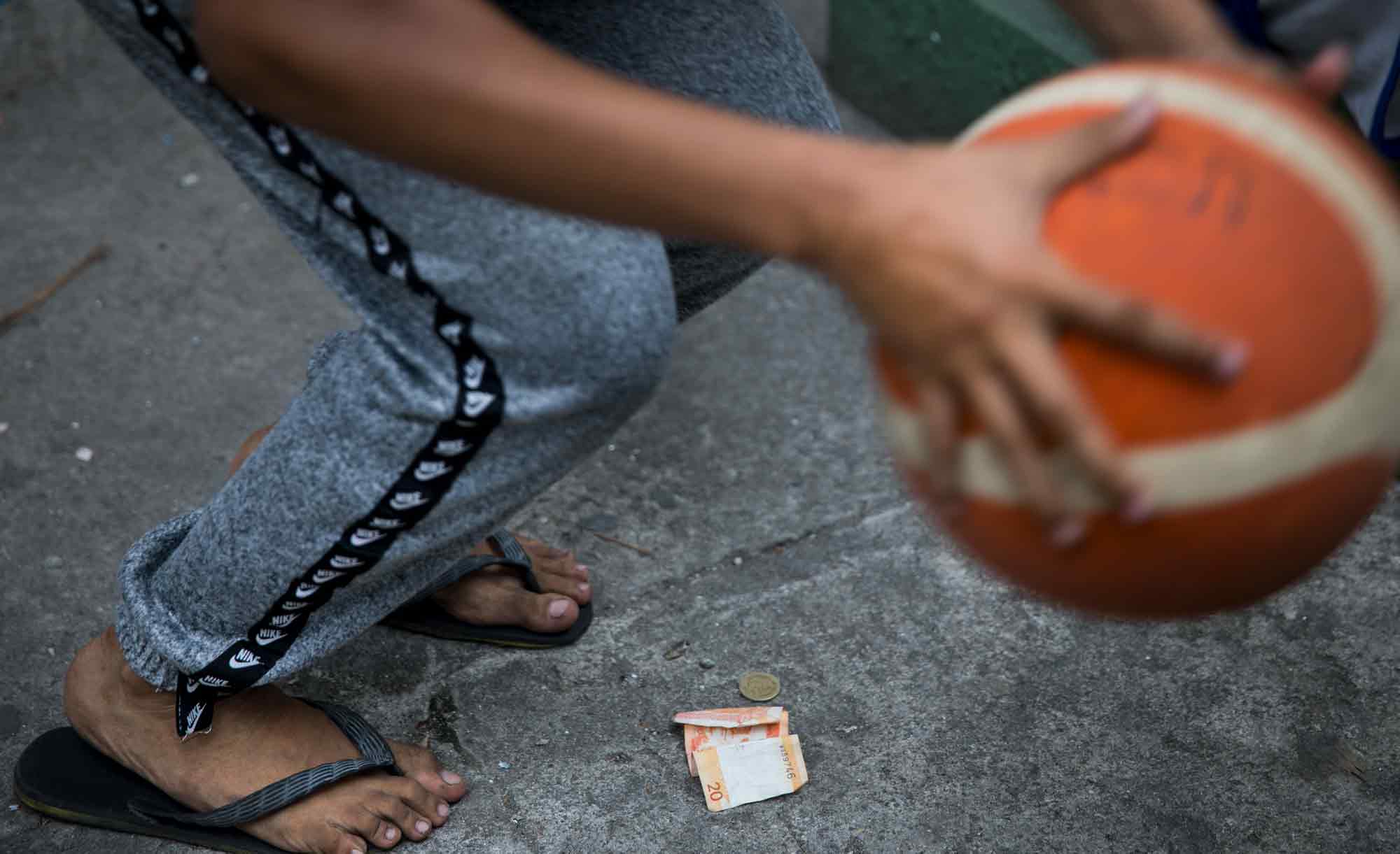 Residents at the Tenement often challenge each other shooting hoops for a few pesos to afford a meal in Taguig, Philippines. The Tenement has been home to players young and old, who passionately occupy its two courts from early morning until late night.