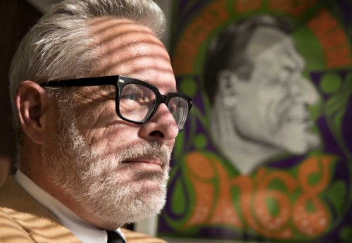Jerry Taylor, president of the Niskanen Center, is a conservative libertarian who supports climate change solutions. He is photographed with a portrait of President Nelson Rockefeller in his office in Washington, D.C., on Friday, November 15, 2019. Portrait of older man with beard silhouetted by a painting of President Nelson Rockefeller