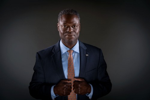 Portrait of Kenneth Manning, cybersecurity analyst. Portrait of a black man in a suit.