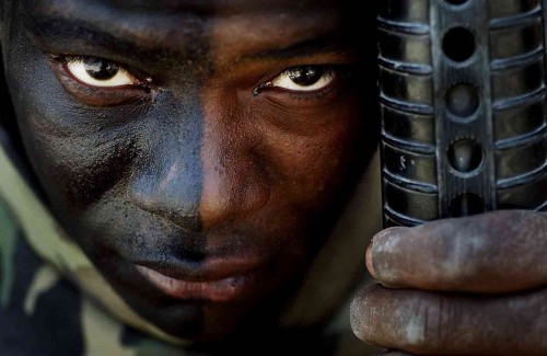 "Maybe they will see my face, be scared, and surrender," said 21-year-old Marine Steve Fountain with a small smile gleaming behind his warrior face paint during the Iraq invasion of 2003. Marine Steve Fountain wears black face paint to instill fear in the Iraqi enemy.